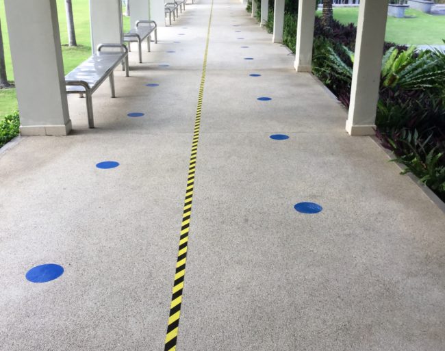 Blue dots and tapes are used to visually remind people to maintain physical distance.